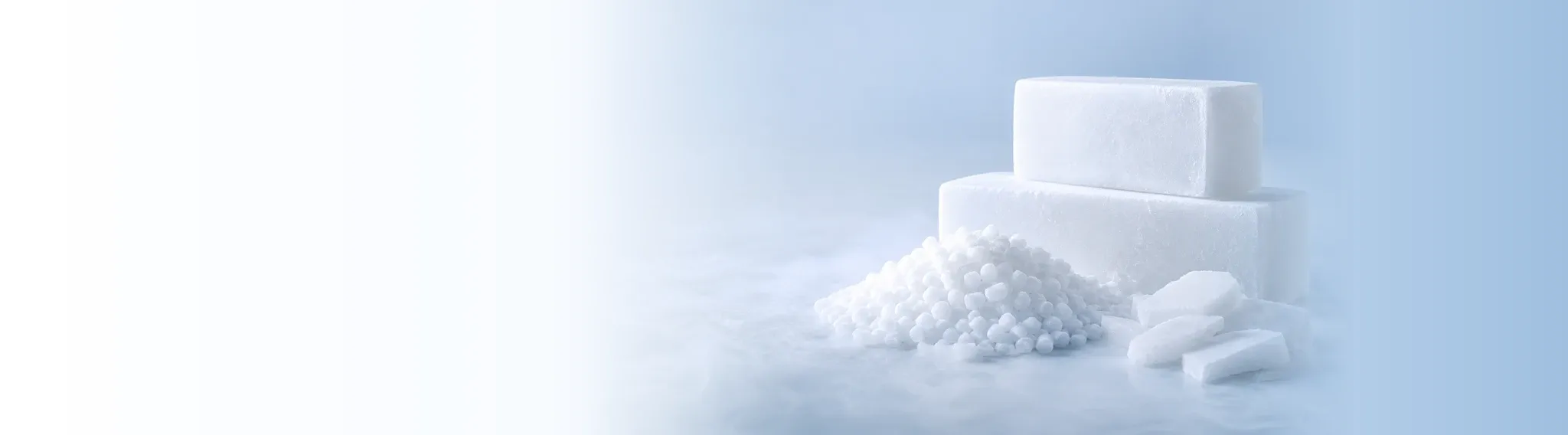 Dry ice pellets and blocks on an ice-blue studio surface